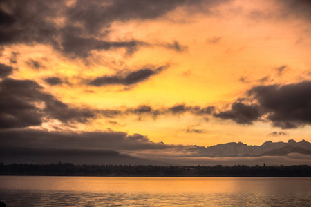 Dramatic clouds at sunrise at Lake Genevaの写真素材