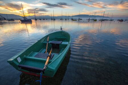 Sunrise and sailboats at a small bay in lake Geneva, Switzerlandの写真素材