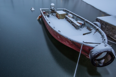 Boat at a Swiss Marina in Versoix covered with snows during winter の写真素材