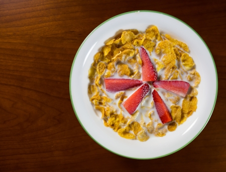 Strawberry and cereal with milk for breakfast の写真素材