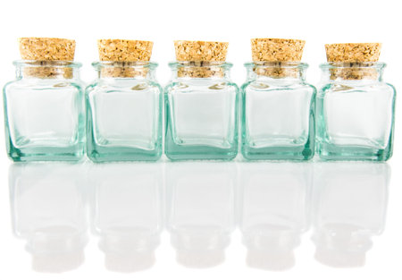 Cork stopper and small glass bottle with white backgroundの写真素材