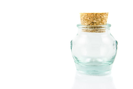 Cork stopper and small glass bottle with white backgroundの写真素材
