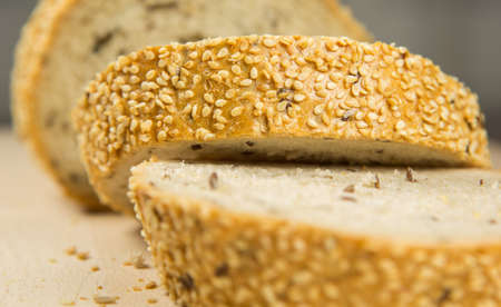 Pieces of sesame seed bread on a pastry boardの写真素材