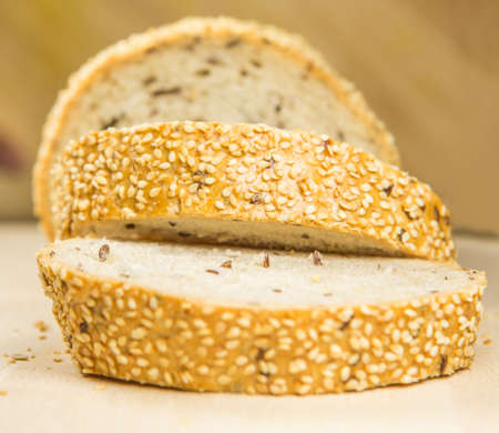 Pieces of sesame seed bread on a pastry boardの写真素材