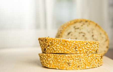 Pieces of sesame seed bread on a pastry boardの写真素材