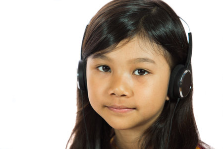 Young Malay  Asian girl listening to music with headphone