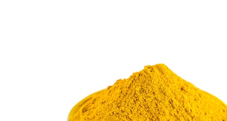 Turmeric powder over white backgroundの写真素材
