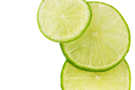 Slices of limes with white background