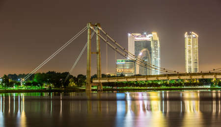 A bridge and modern buildings in Putrajaya, Malaysia at nightのeditorial素材
