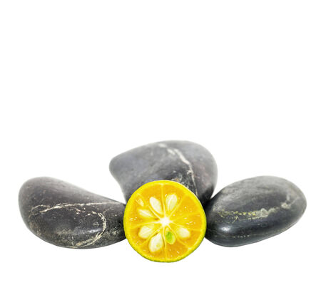 Calamondin and zen stones over white backgroundの写真素材
