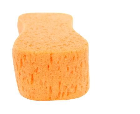 Orange sponge over white background の写真素材