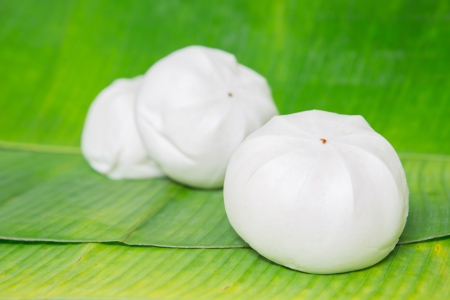 Chinese steamed bun on banana leaveの写真素材