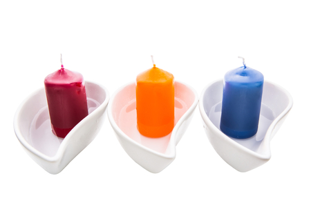 Aromatic candle in a ceramic container over white backgroundの写真素材