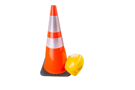 Safety helmet and traffic cone over white background