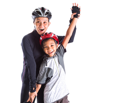 Mother and daughter with cycling attire over white backgroundの写真素材