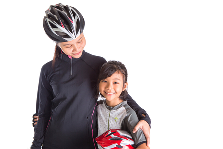 Mother and daughter with cycling attire over white backgroundの写真素材
