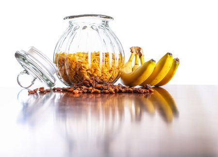 Jar of cereal, raisin and banana on a table