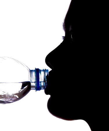 Female drinking mineral water silhouetteの写真素材