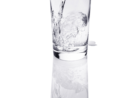 Pouring water into a glassの写真素材