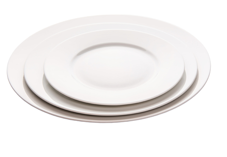 Three empty plates of different sizes over white backgroundの写真素材