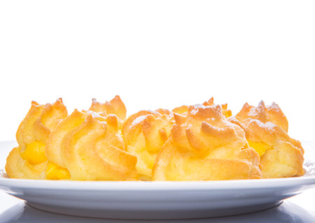 Homemade cream puff over white background
