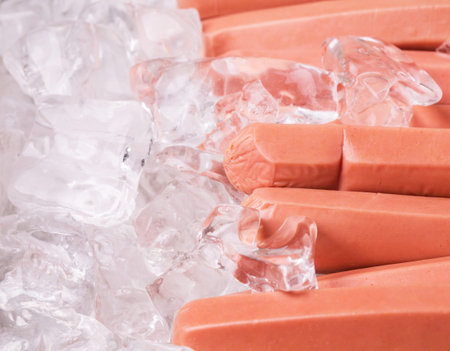 A group of sausages kept fresh on ice cubesの写真素材