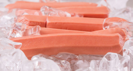 A group of sausages kept fresh on ice cubesの写真素材
