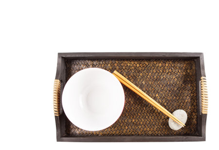 A pair of chopstick, a red polka dot bowl on a wooden tray の写真素材