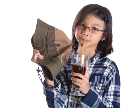 A young asian girl wearing a shirt and a hat while holding a cold drink over white backgroundの写真素材