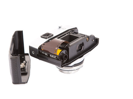 Old retro analog camera with new film roll over white background