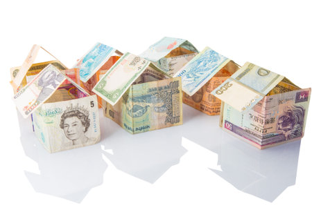 Concept image of houses made from various countries bank notes