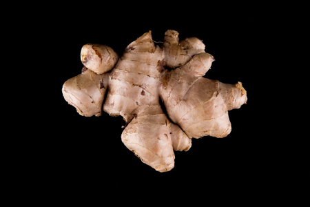 Fresh ginger root over black backgroundの写真素材