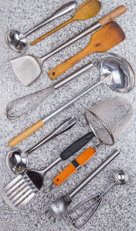 A collection of kitchen utensil on granite surface 