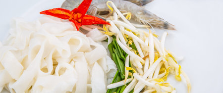 Fried char kway teow ingredients of raw rice strips, prawns and bean sprouts 
