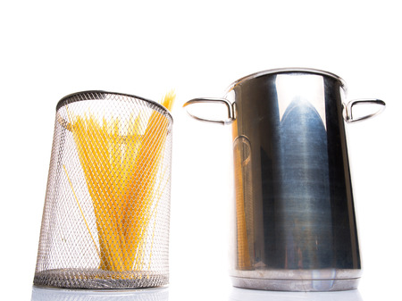 A bunch of dried spaghetti in a steel pot の写真素材