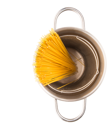 A bunch of dried spaghetti in a steel pot の写真素材