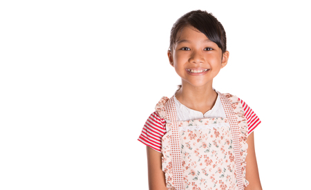 Young Asian Malay girl wearing kitchen apron over white backgroundの写真素材