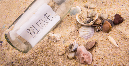 Concept image of a message BELIEVE in a bottleの写真素材