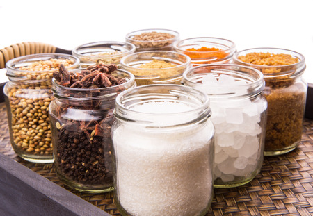 Sugar and spices in a wicker trayの写真素材