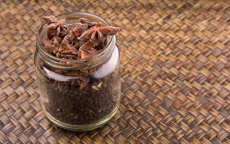 Star anise spice over a wicker background の写真素材