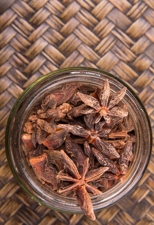 Star anise spice over a wicker background の写真素材