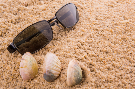 sunglasses on beach sandの写真素材