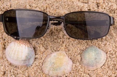 sunglasses on beach sandの写真素材