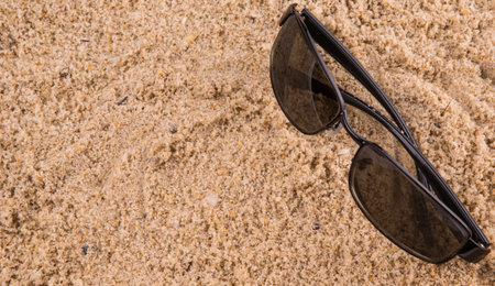 sunglasses on beach sandの写真素材