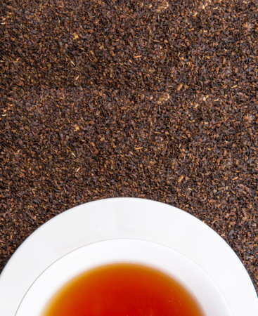 A cup of tea on dried and processed tea leavesの写真素材