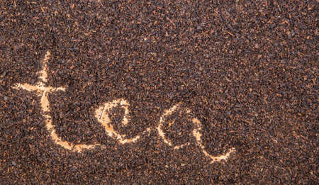 Written TEA word on dried tea leavesの写真素材