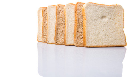 Whole wheat bread and sandwich bread over white background 