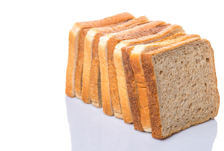 Whole wheat bread and sandwich bread over white background 