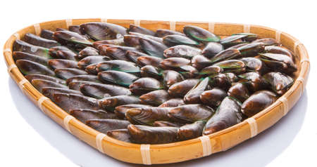 A group of mussel in a wicker tray over white backgroundの写真素材