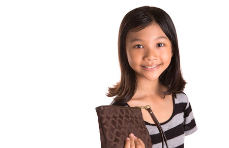 Young Asian Malay girl with  purse over white backgroundの写真素材